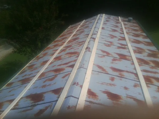 Rusted metal roof panels with new wood purlins before replacement — Storm Damage Roof Repair in Letart by Roofing Brothers