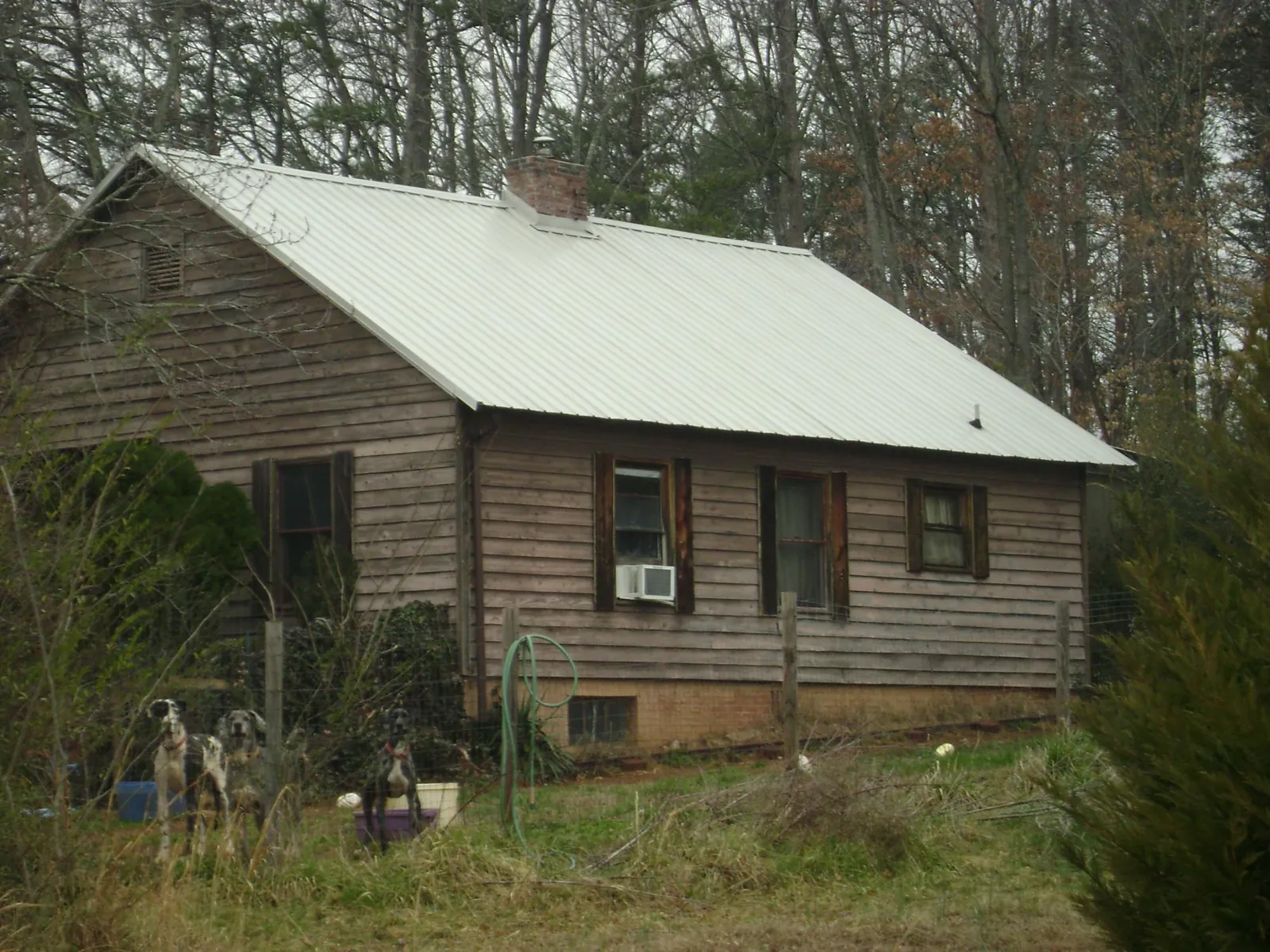 White metal roof on an old wood sided farmhouse, from a Metal Roof Installation job in Letart